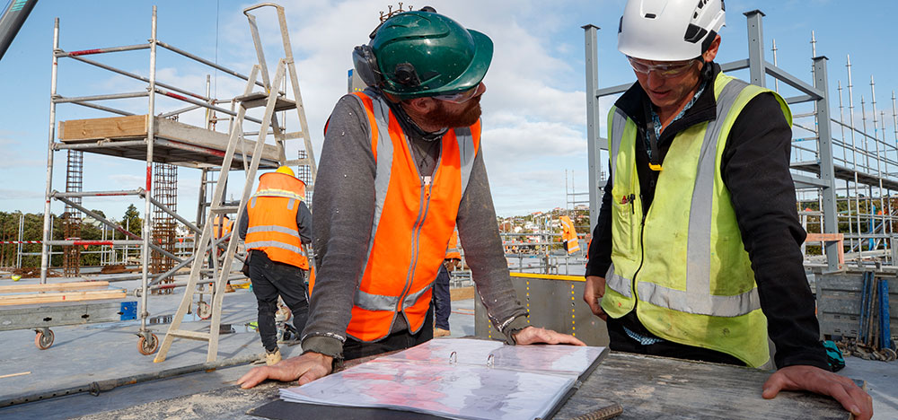 Contractors on site looking over plans