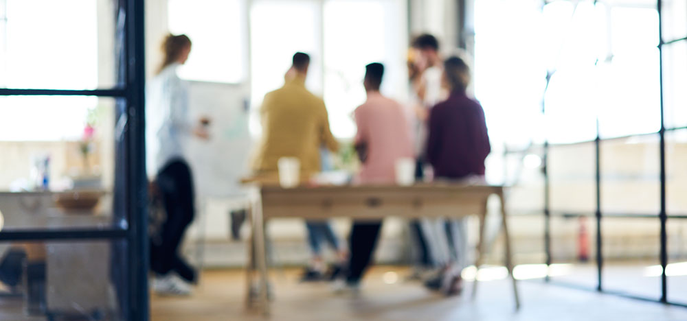 People meeting around standing table